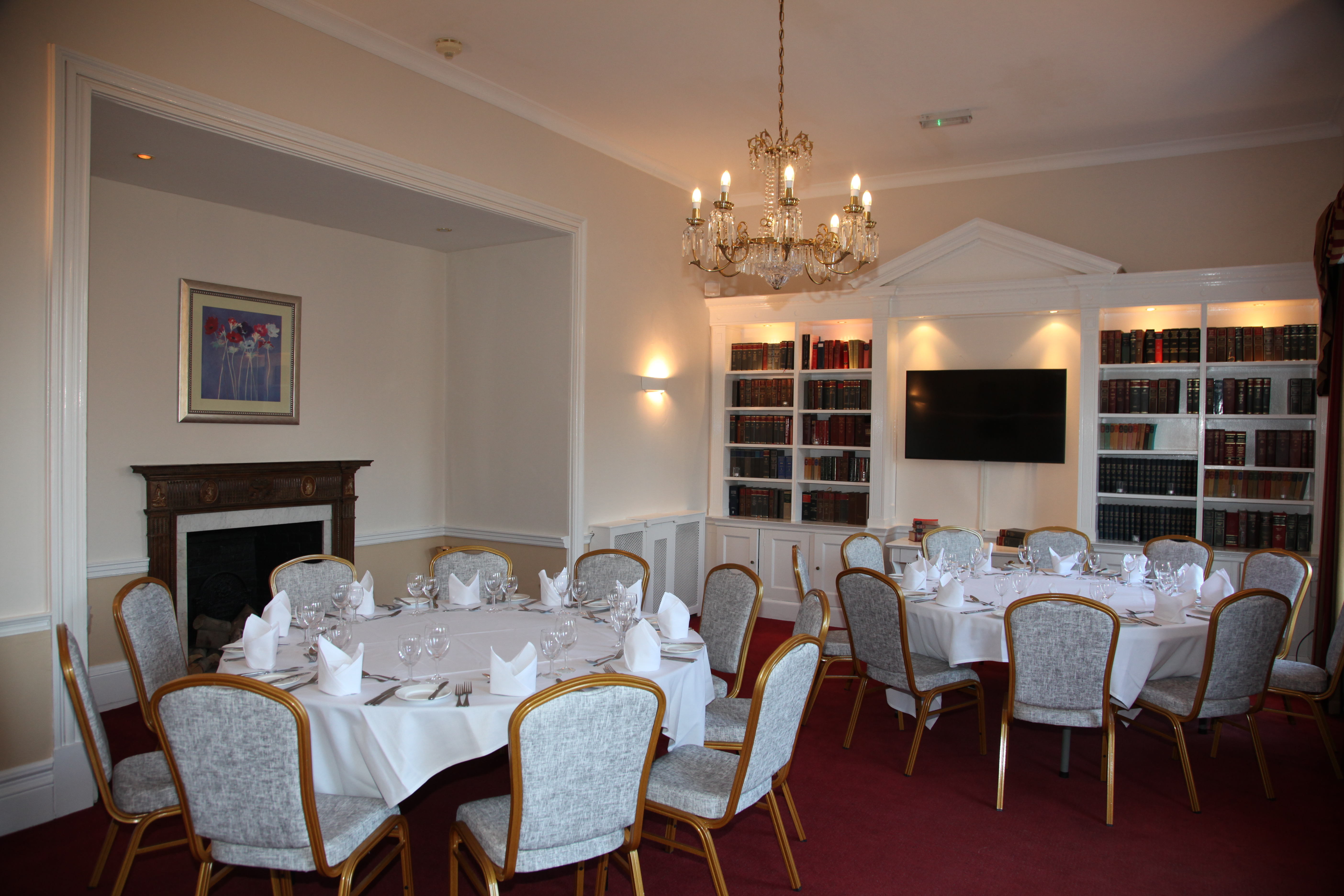 Elegant meeting room with chandelier at Manor of Groves Hotel for corporate events.