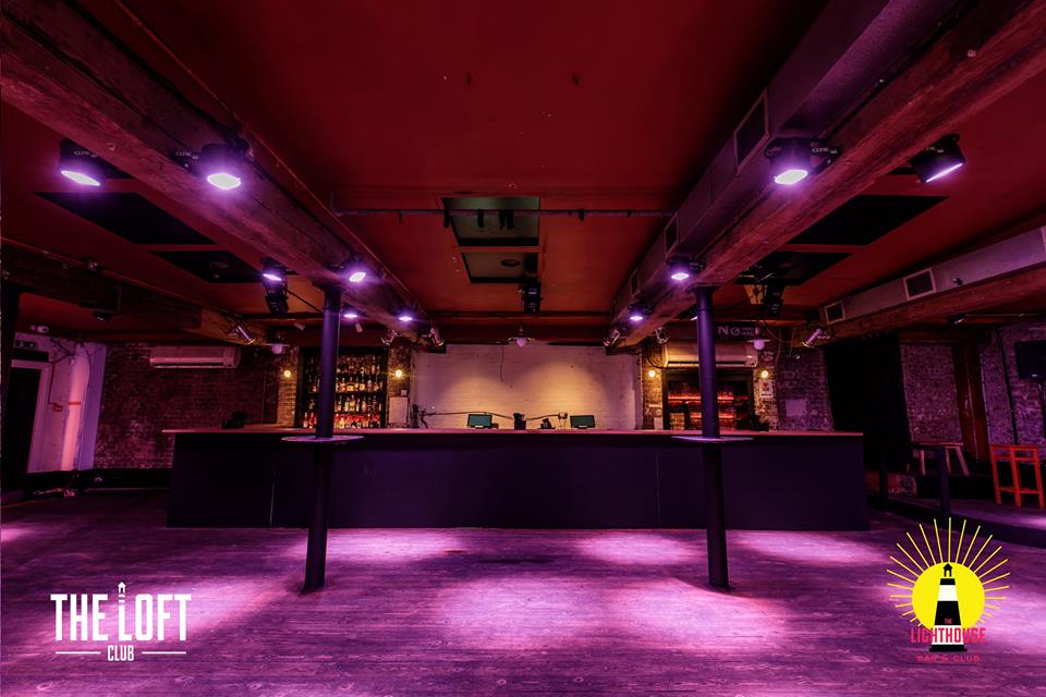 Upstairs at The Lighthouse: industrial-chic event space with bar for gatherings and networking.