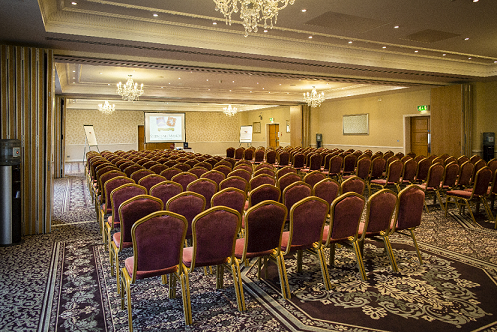 Aspley Suite conference room with plush chairs, ideal for seminars and workshops.