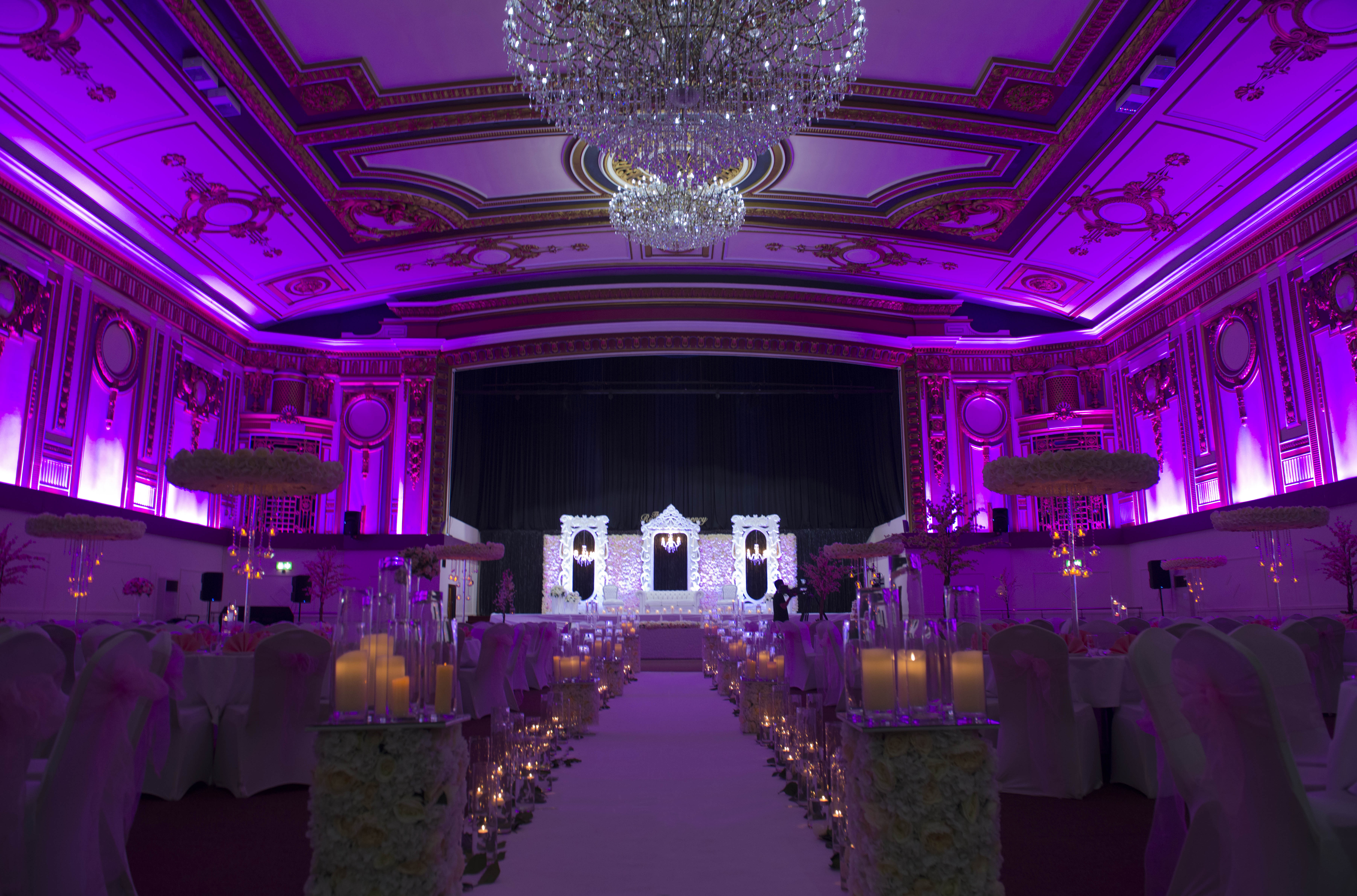 Grand Ballroom at The Royal Regency, elegant space for weddings and galas with purple lighting.