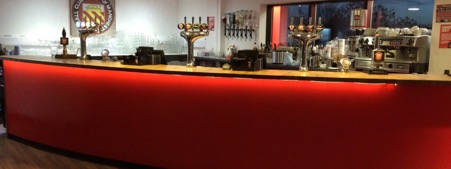 Sleek bar setup in FC United's Function Room for networking events and social gatherings.
