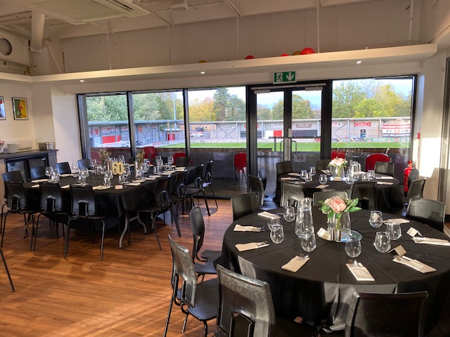 Elegant event space with round tables, ideal for gatherings at FC United of Manchester.