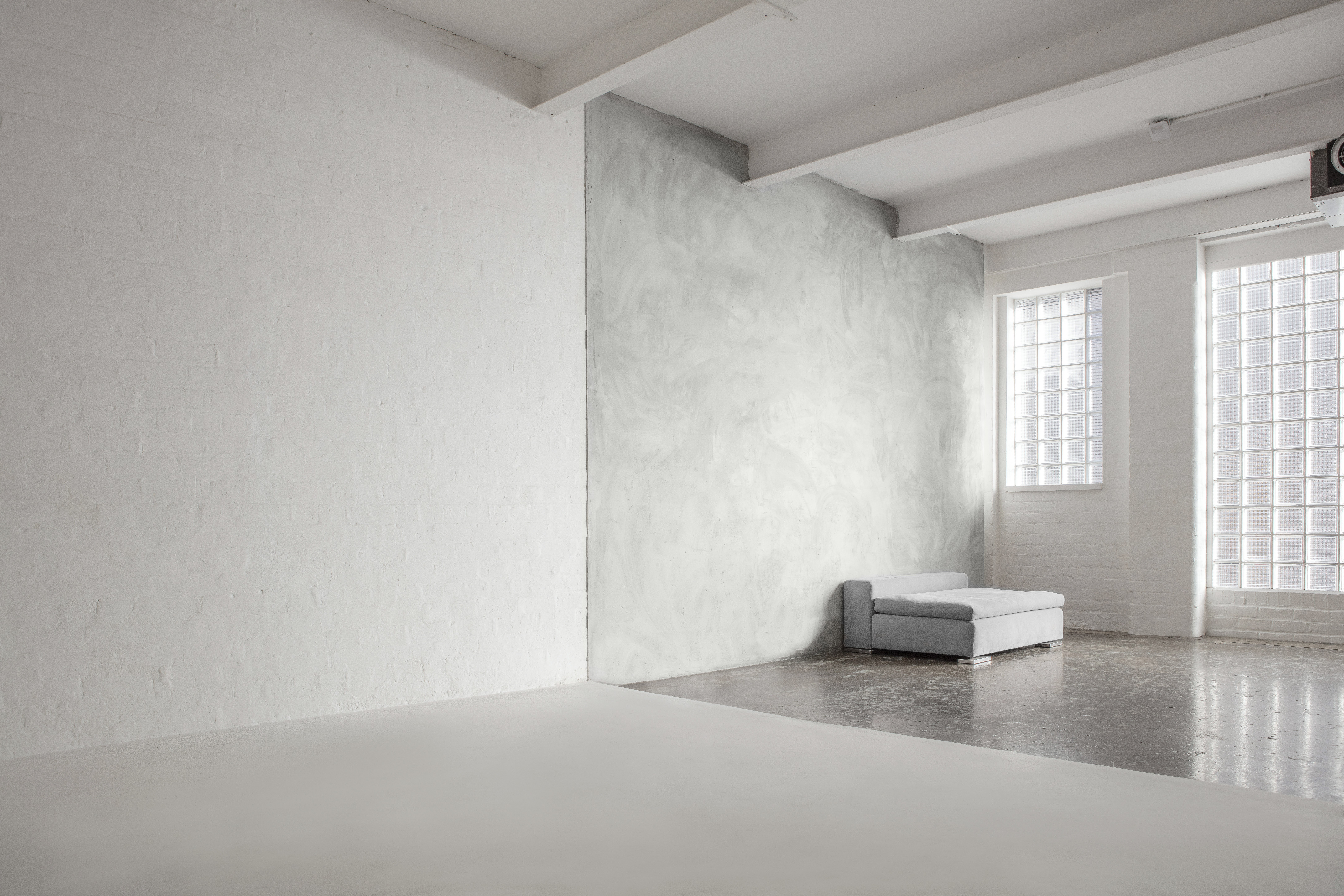 Versatile minimalist event space with natural light at FiveFour Studios for workshops and meetings.