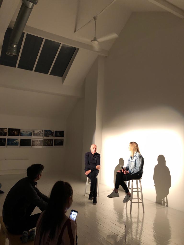 Loft panel discussion setup with speakers in minimalist space for engaging events.