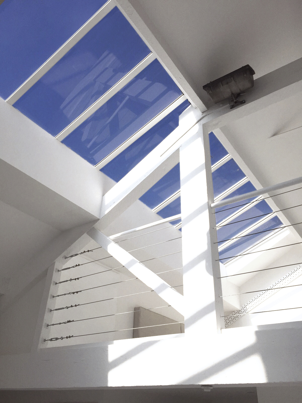 Bright modern event space with skylight, perfect for meetings and workshops.