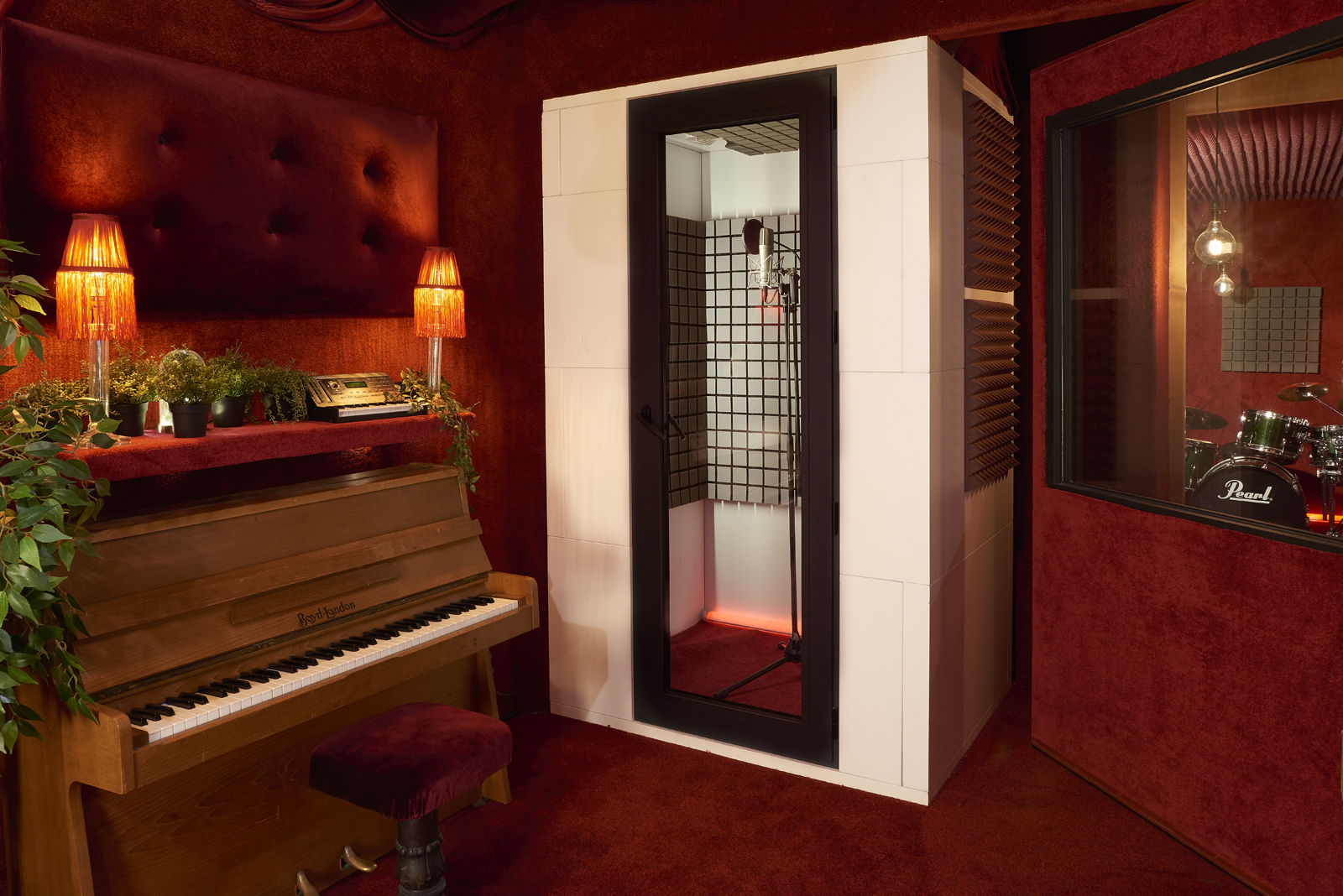 Soundproof booth in stylish event space for private meetings and recording sessions.