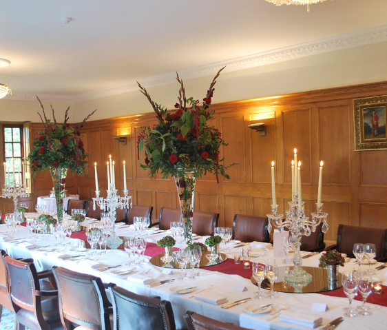 Elegant dining table with floral arrangements for formal events at Pennyhill Park.