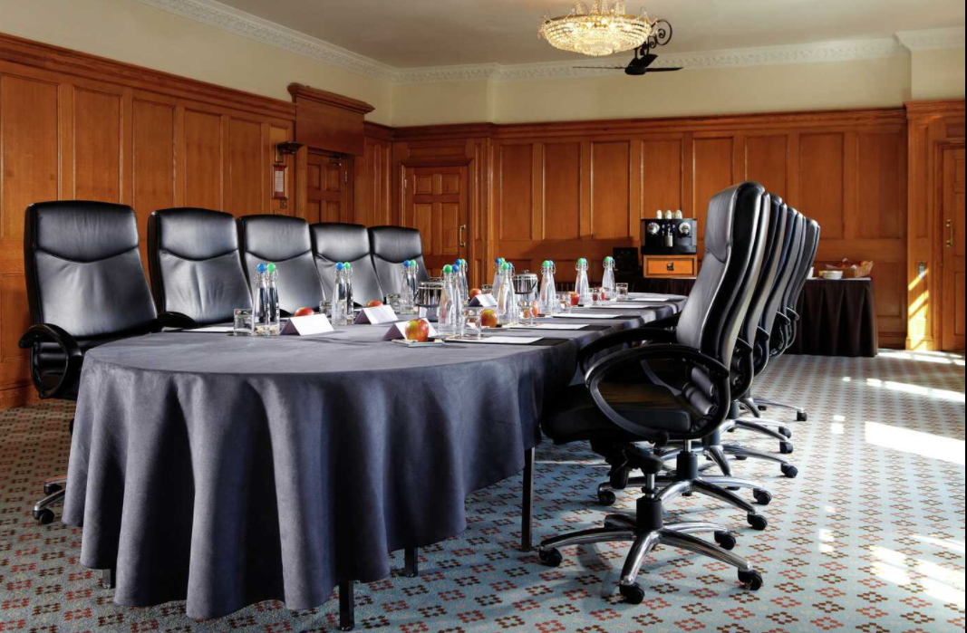 Elegant meeting room in Pennyhill Park with wooden paneling for professional gatherings.
