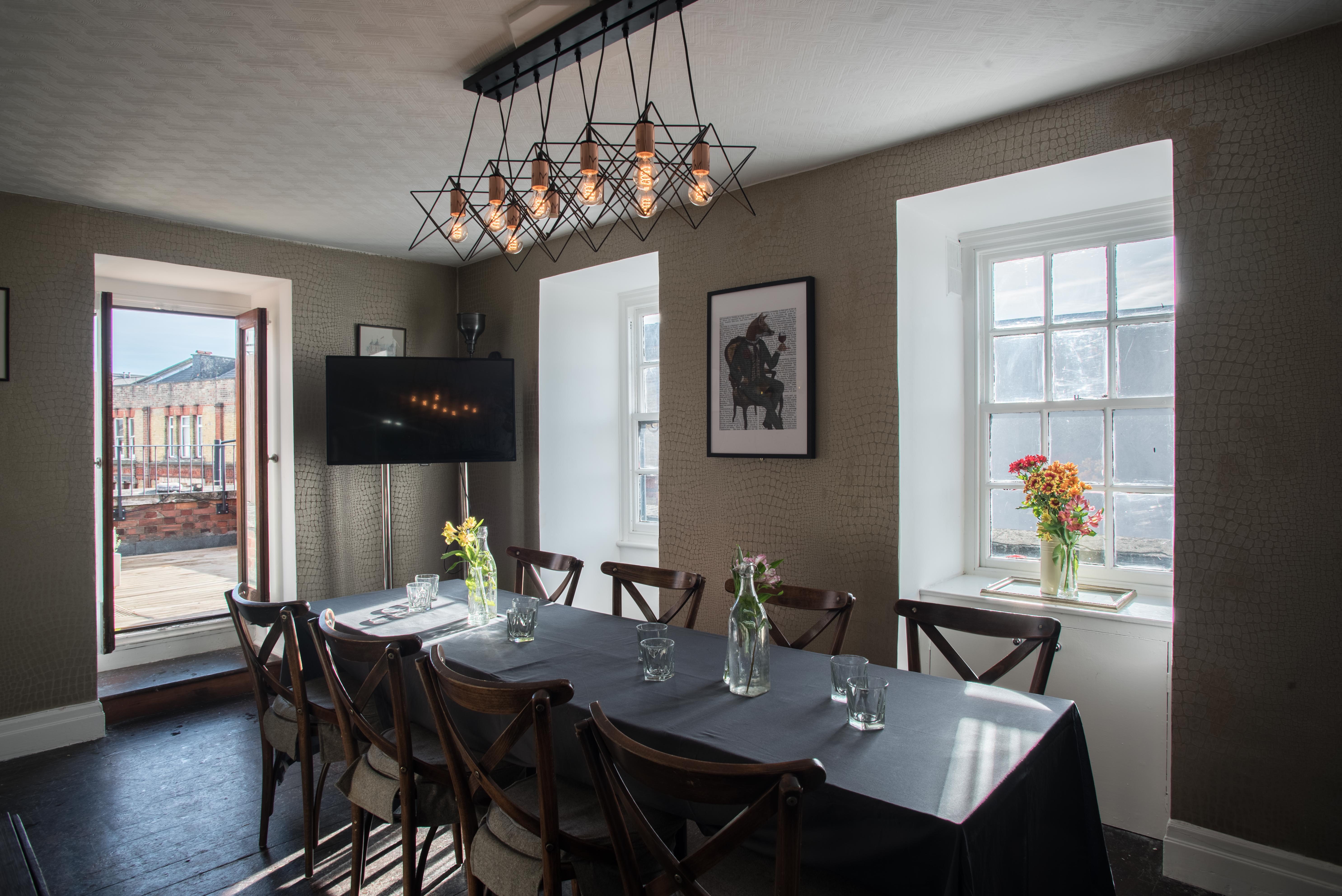 Private dining room with long table, ideal for intimate meetings and events.