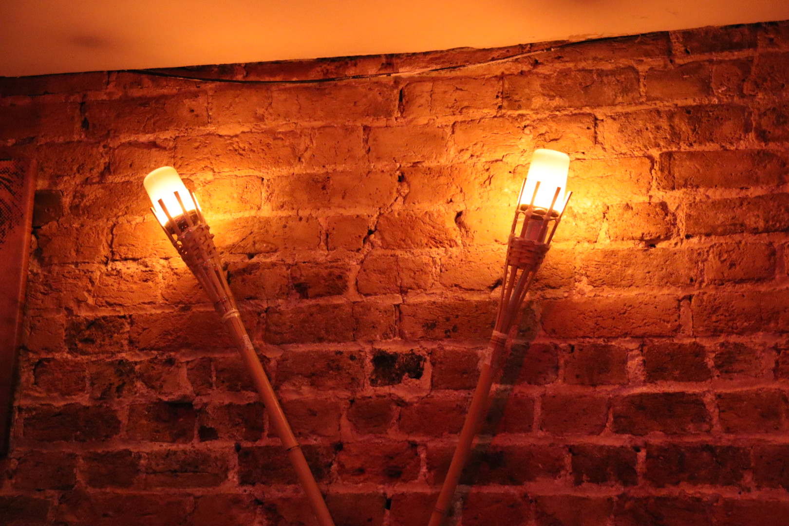 Private hire event at CC Lounge Bar with vintage sconces and rustic brick ambiance.