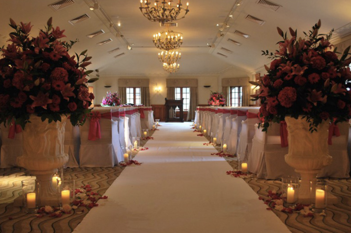 Elegant wedding ceremony in The Balmoral Suite, adorned with floral arrangements and soft lighting.