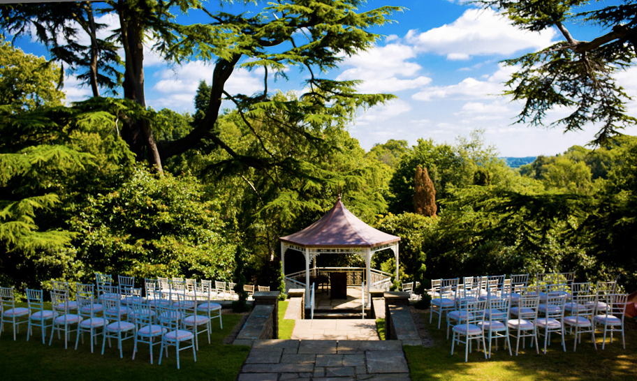 Balmoral Suite gazebo in lush garden, perfect for weddings and corporate events.