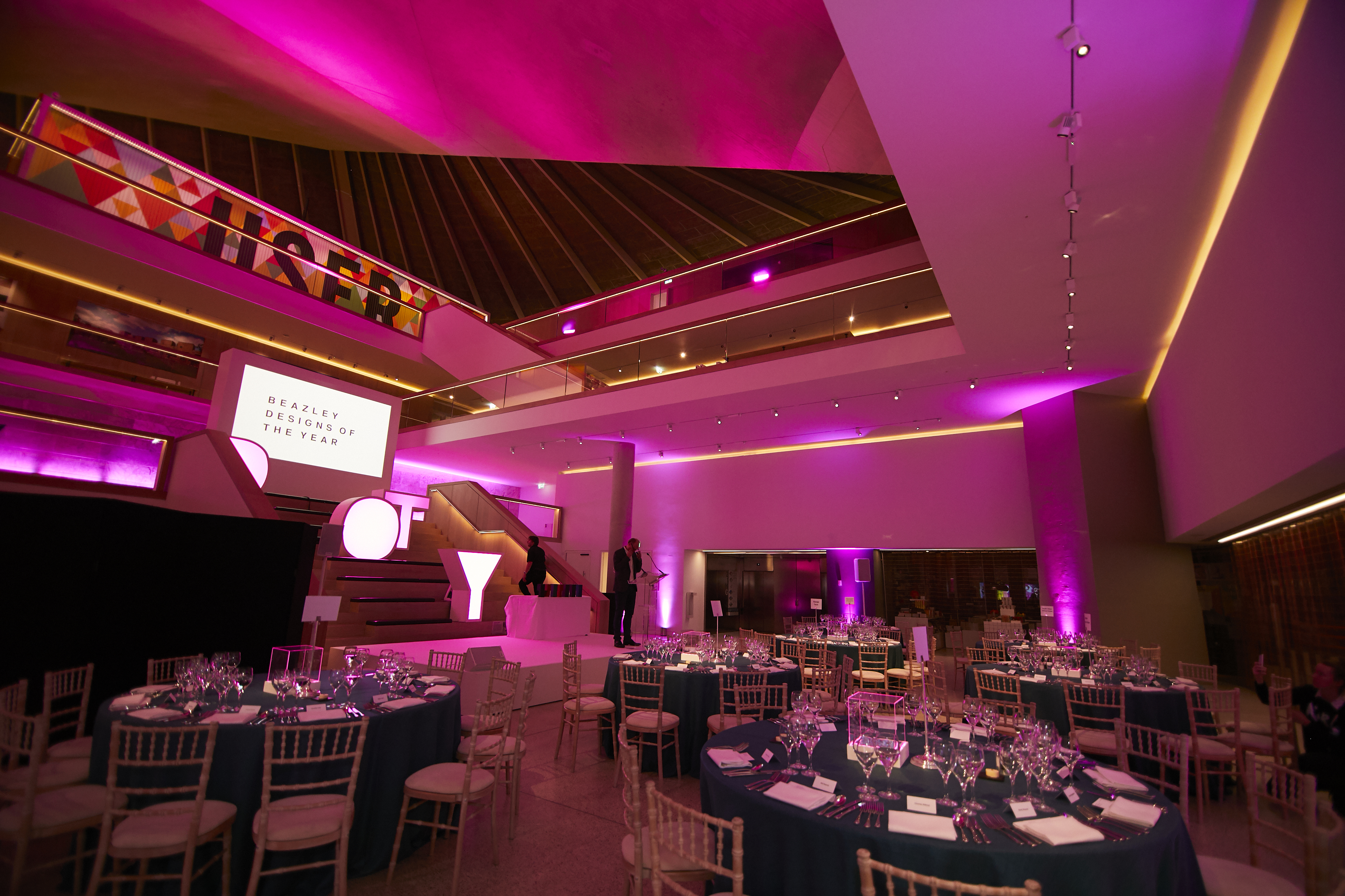 Elegant event space in Design Museum's Atrium with purple lighting for corporate events.