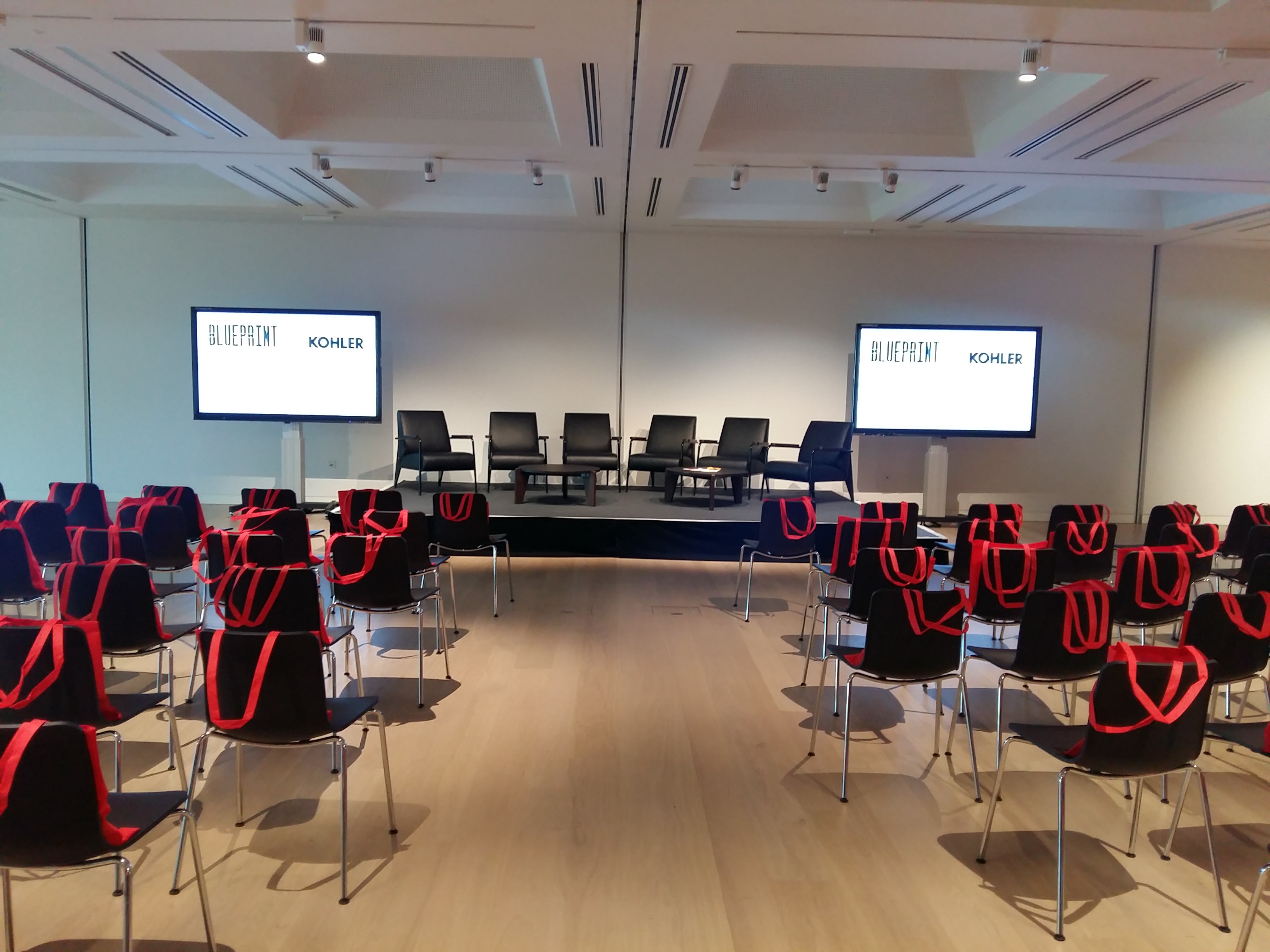 "Panel discussion setup at Helene and Johannes Huth Gallery, Design Museum with branded seating."