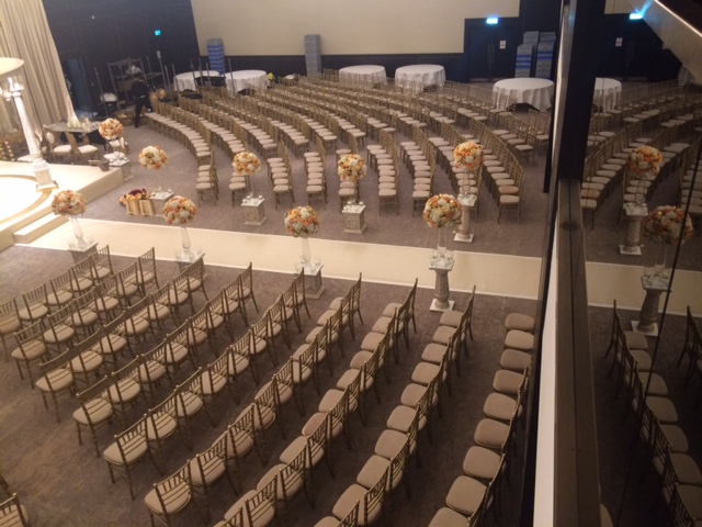 Bankside Ballroom setup for a formal event with elegant chairs and floral centerpieces.