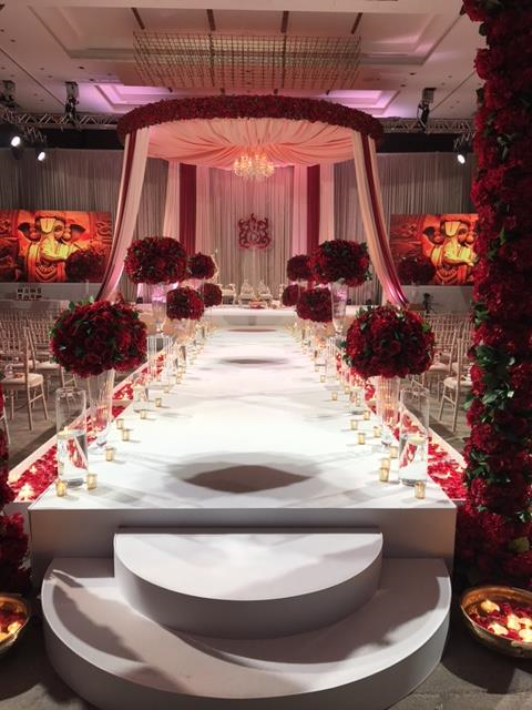Elegant wedding venue at Hilton London Bankside with floral aisle and chandelier.