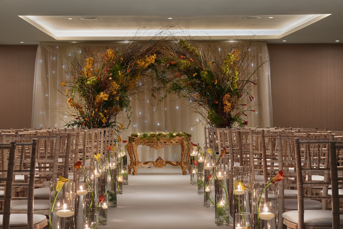 Elegant Bankside Ballroom ceremony setup with chiavari chairs and floral archway for weddings.