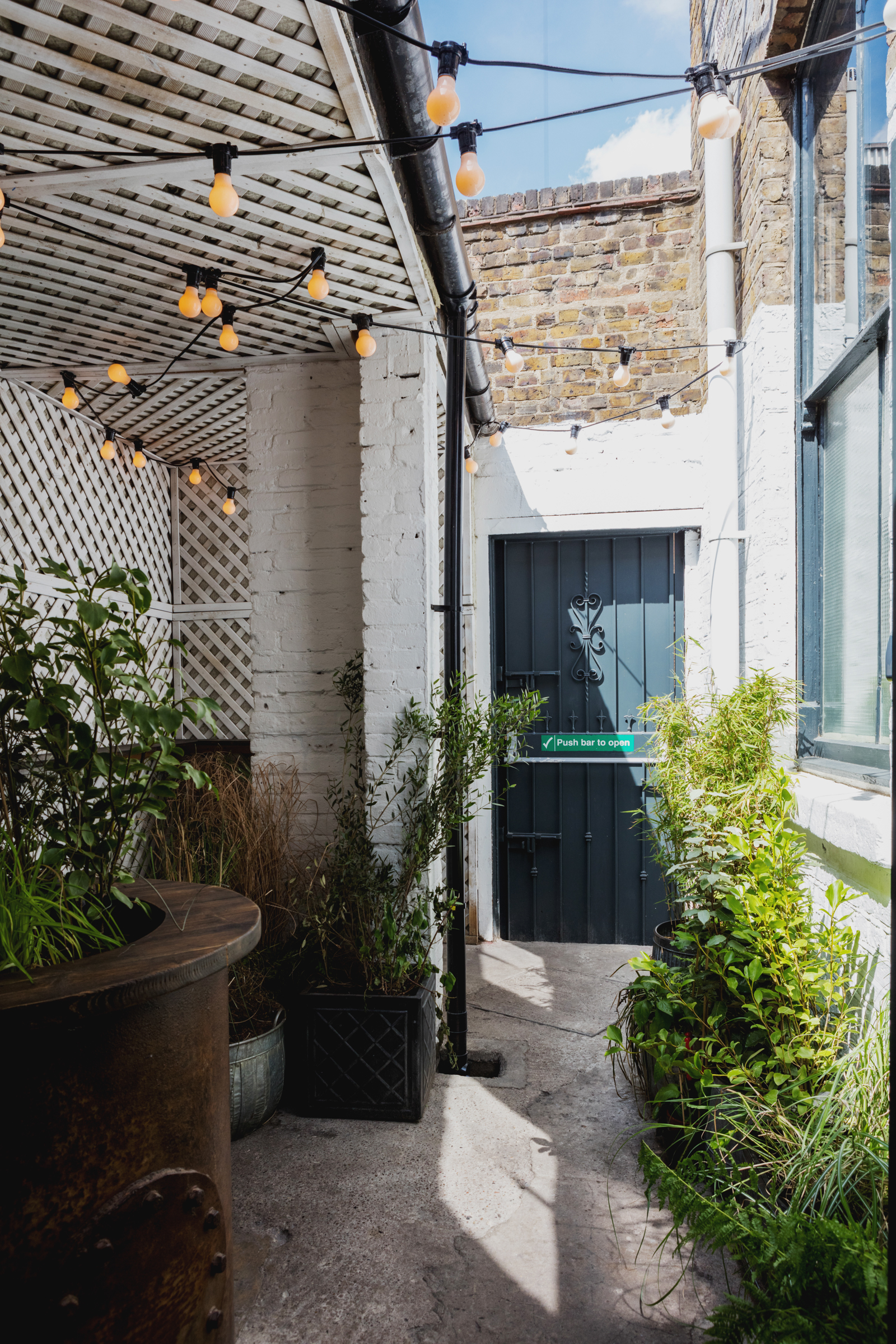 Charming outdoor venue at Martello Hall with string lights for intimate gatherings.
