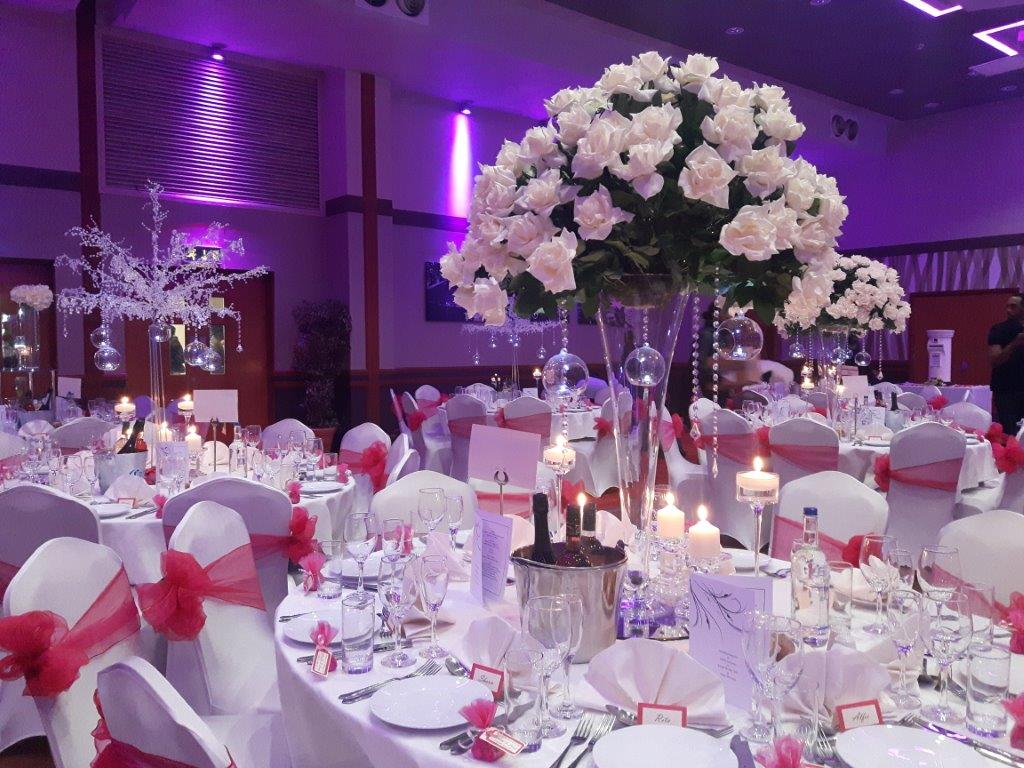 Elegant wedding venue at The Riverside with floral centerpieces and soft lighting.