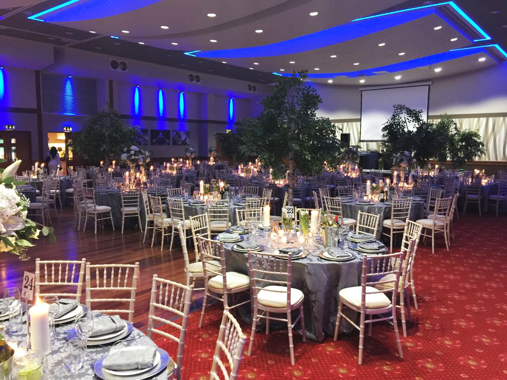 Elegant banquet hall with blue tablecloths, ideal for weddings and corporate events.