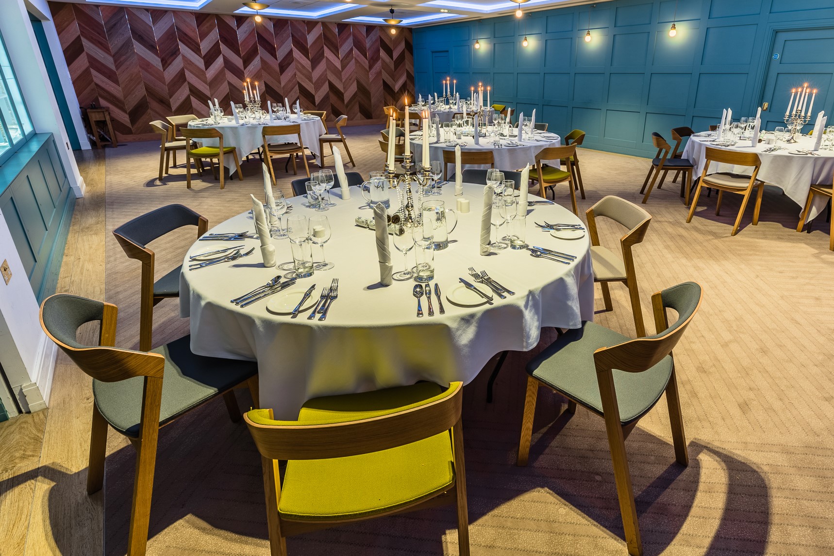 Elegant Great Hall with round tables, ideal for weddings and corporate events.