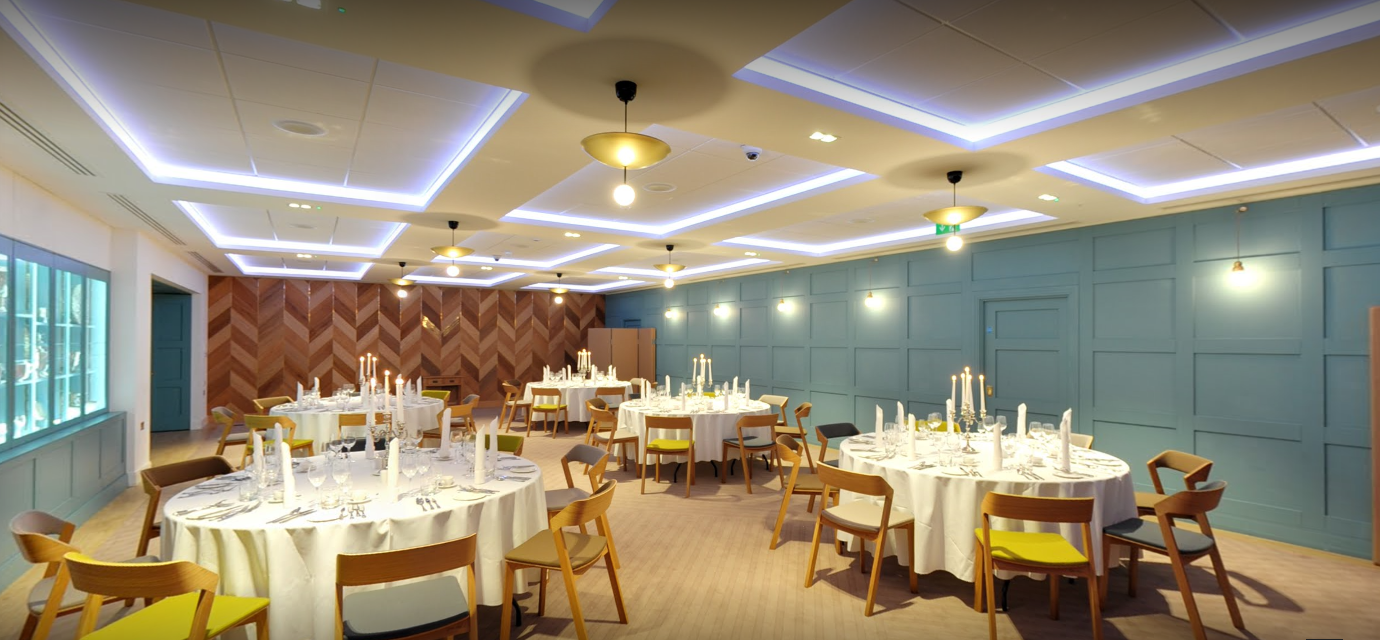 Elegant event space in The Great Hall with round tables, ideal for formal gatherings.