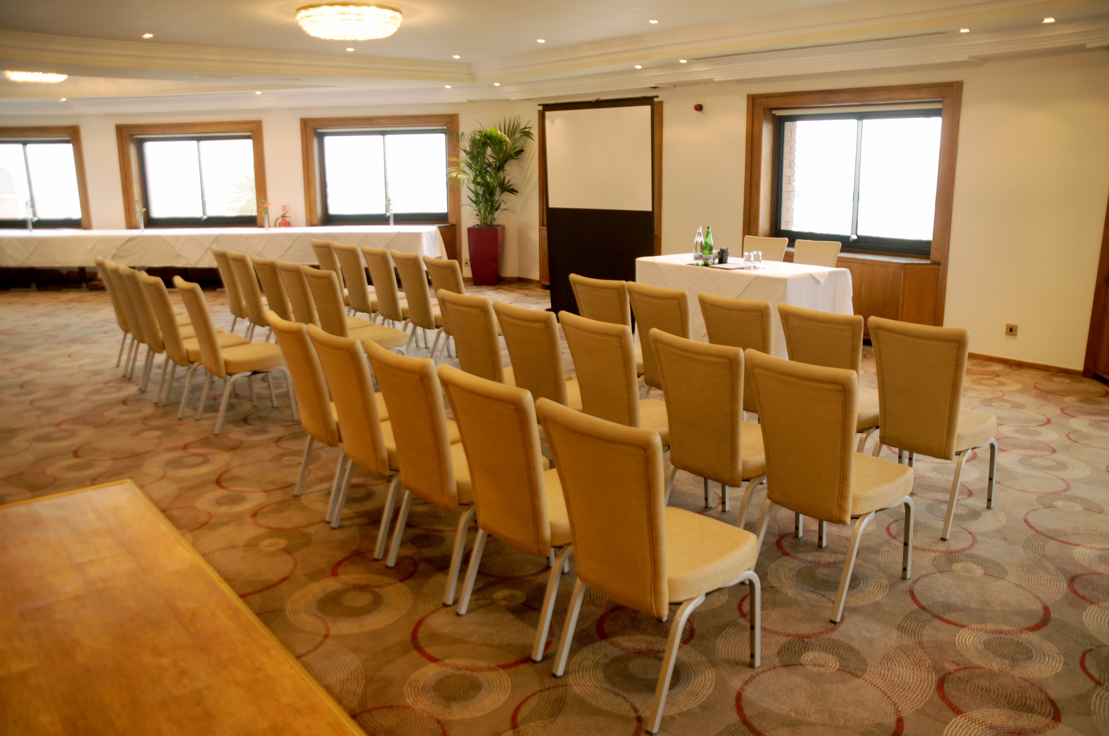 Harbour View Restaurant meeting space with beige chairs, ideal for presentations and events.