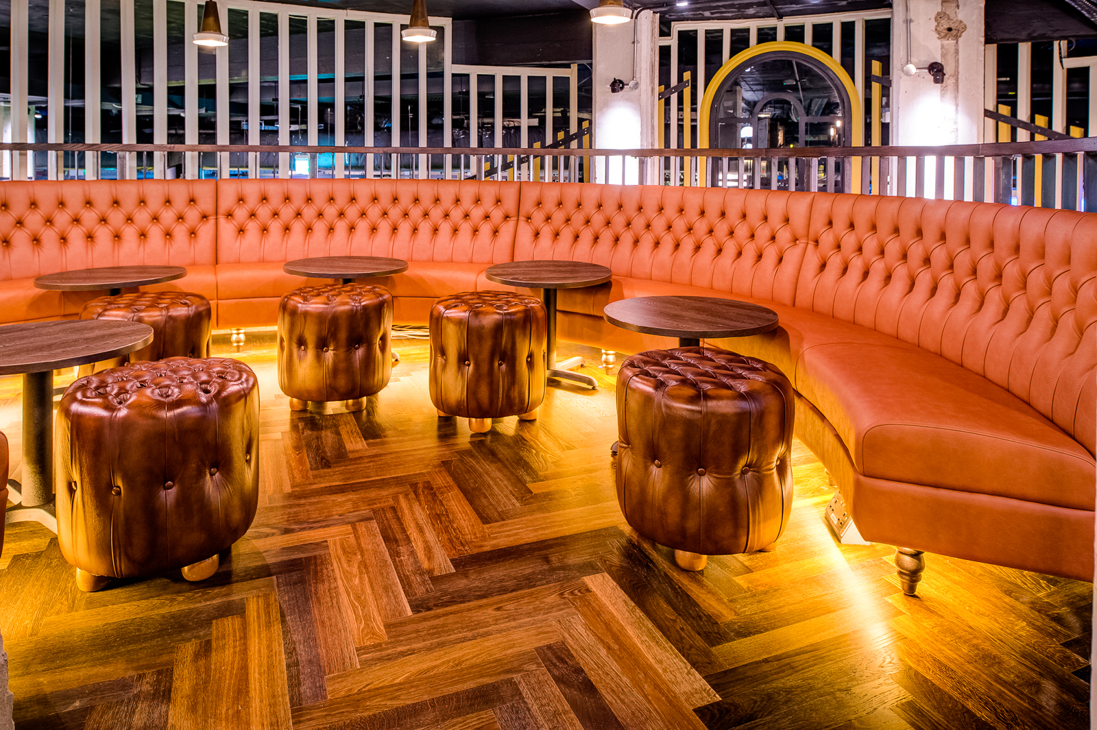 Stylish lounge with tufted leather seating in Swingers City for networking events.