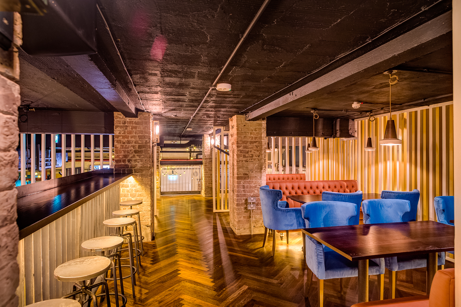 Upperclub House & Gin Terrace: modern event space with cozy seating for networking events.