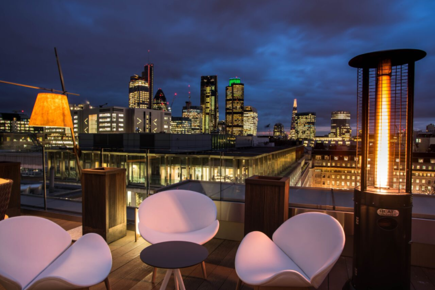 Stylish rooftop venue with city skyline, ideal for upscale events and gatherings.