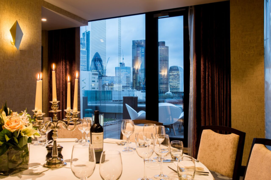 Elegant dining table with candlelight in Palm Rooms, perfect for upscale corporate events.