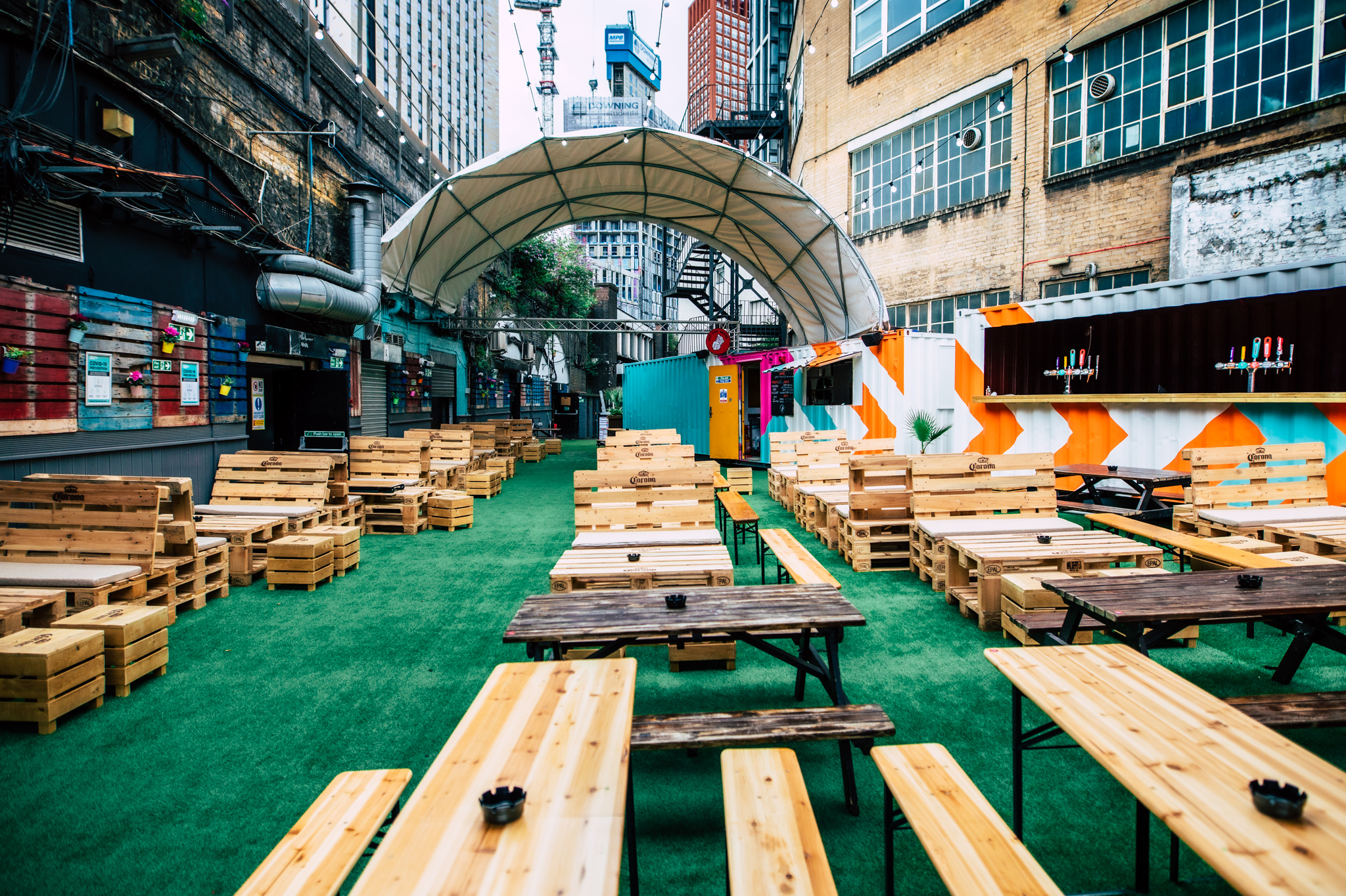 Vauxhall Street Food Garden with wooden seating, ideal for outdoor events and gatherings.