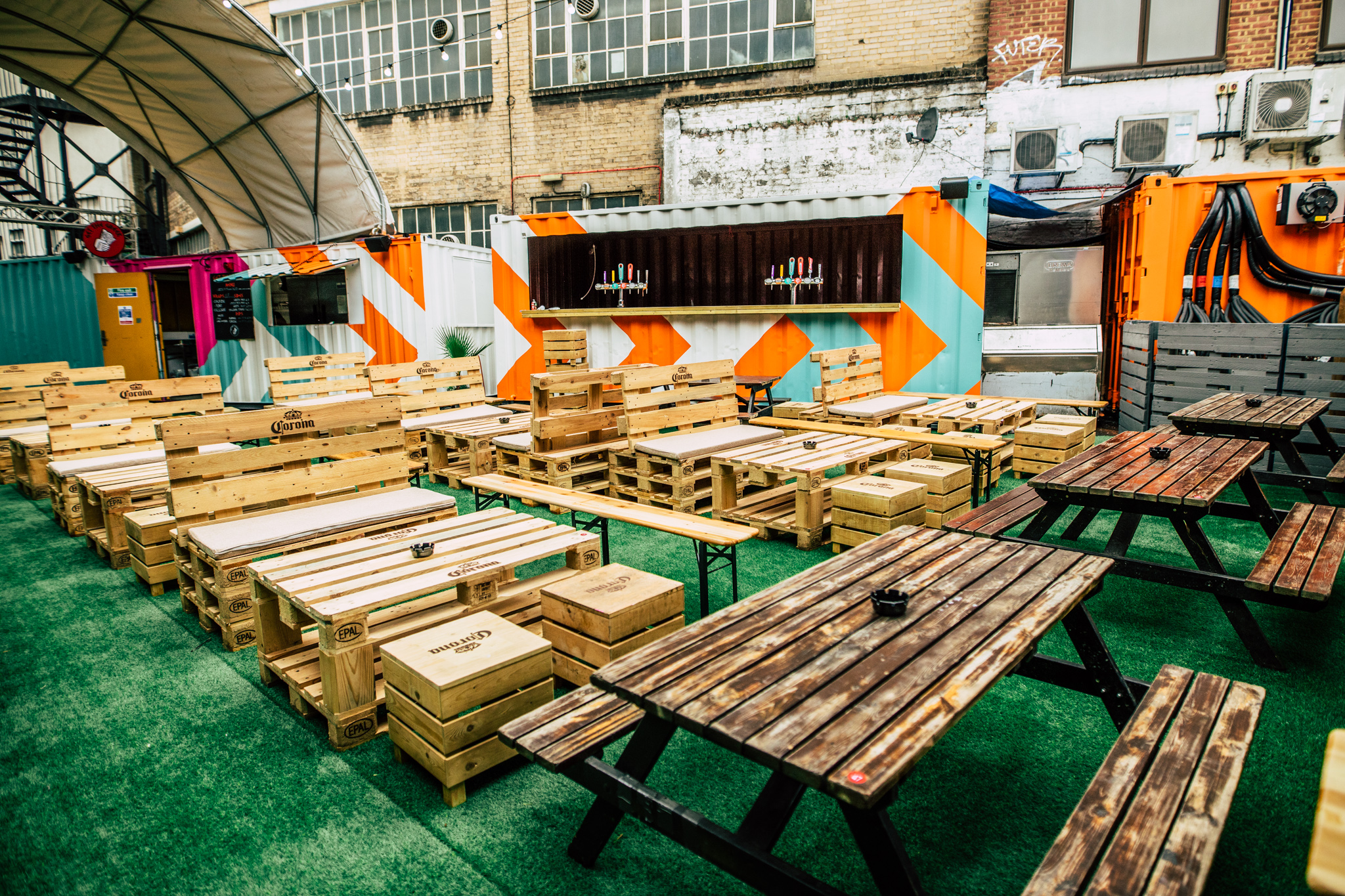Vauxhall Street Food Garden with wooden seating, perfect for casual gatherings and networking.