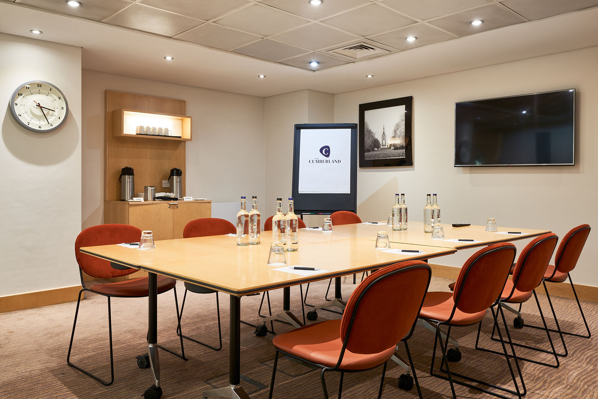 Meeting room in The Cumberland Hotel with large table and presentation screen.