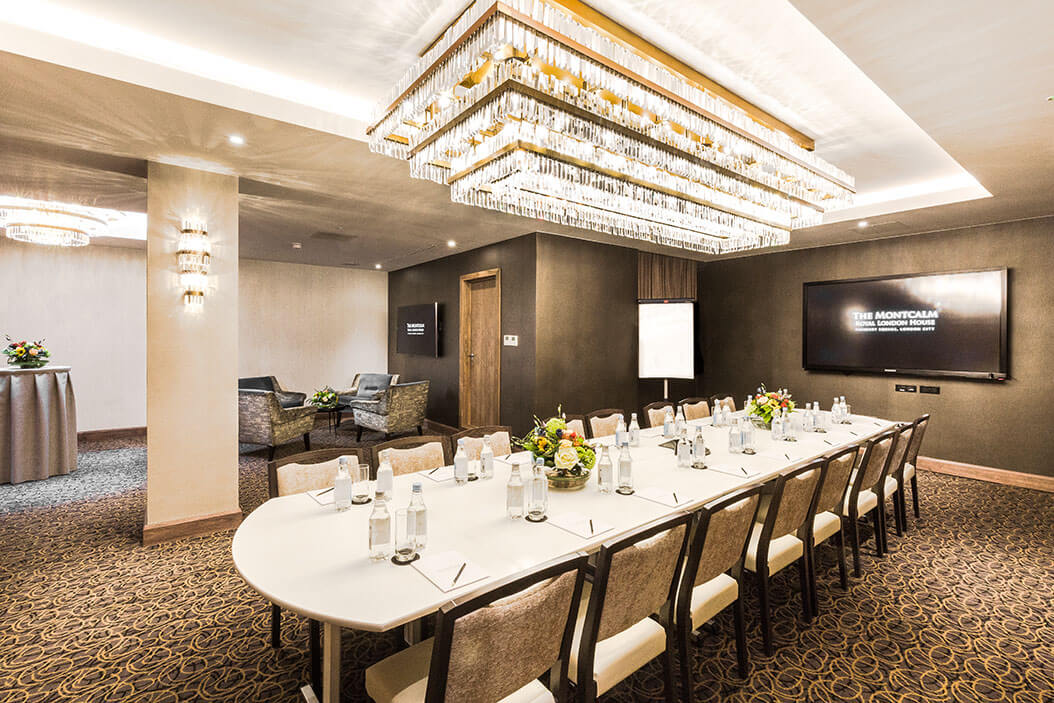 Sophisticated meeting room in Royal London House with elegant chandelier, ideal for corporate events.