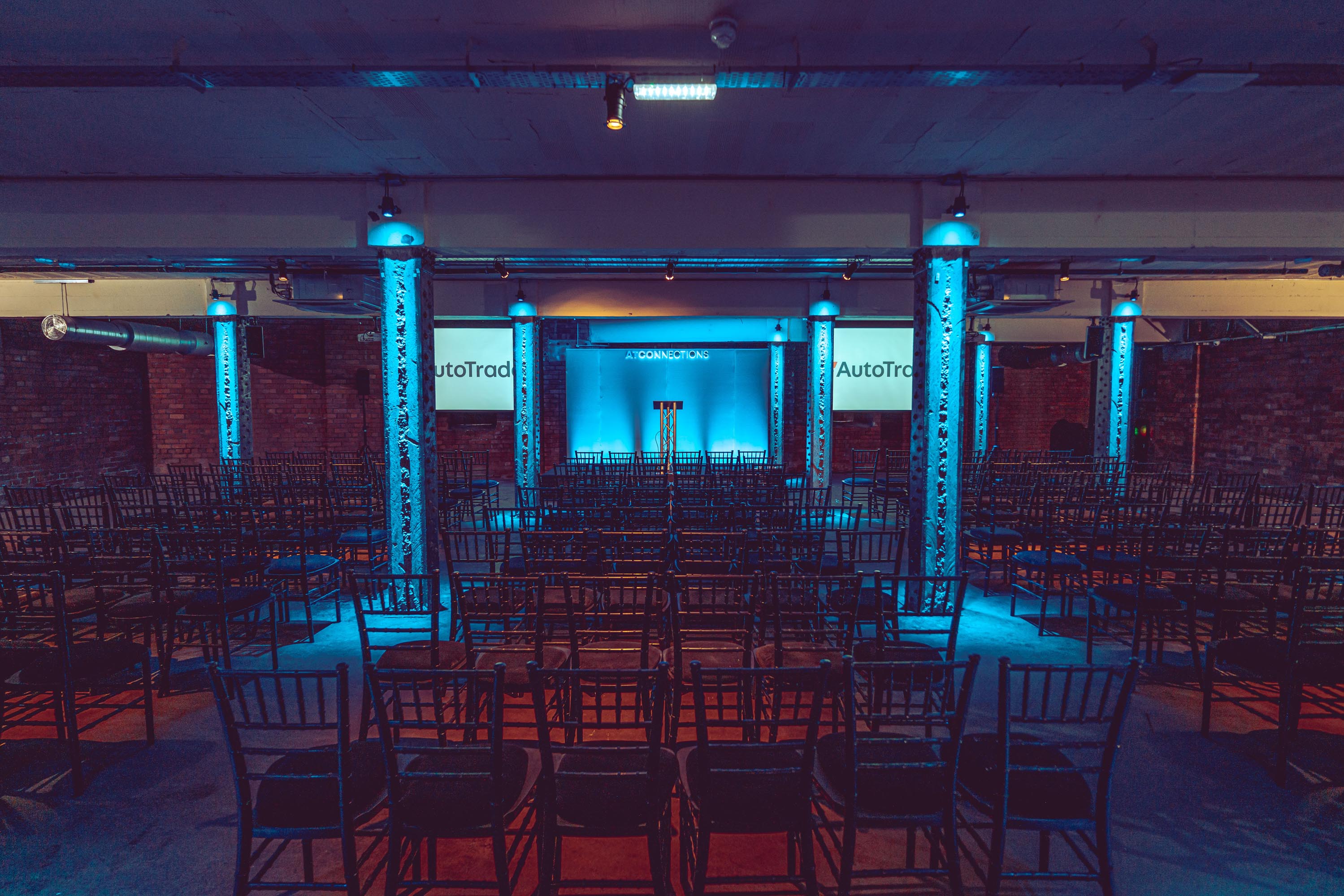 Event space at Victoria Warehouse with blue lighting, ideal for conferences and presentations.