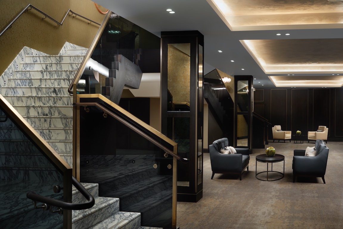 Sophisticated Hilton London Bankside lobby with marble stairs, ideal for corporate events.