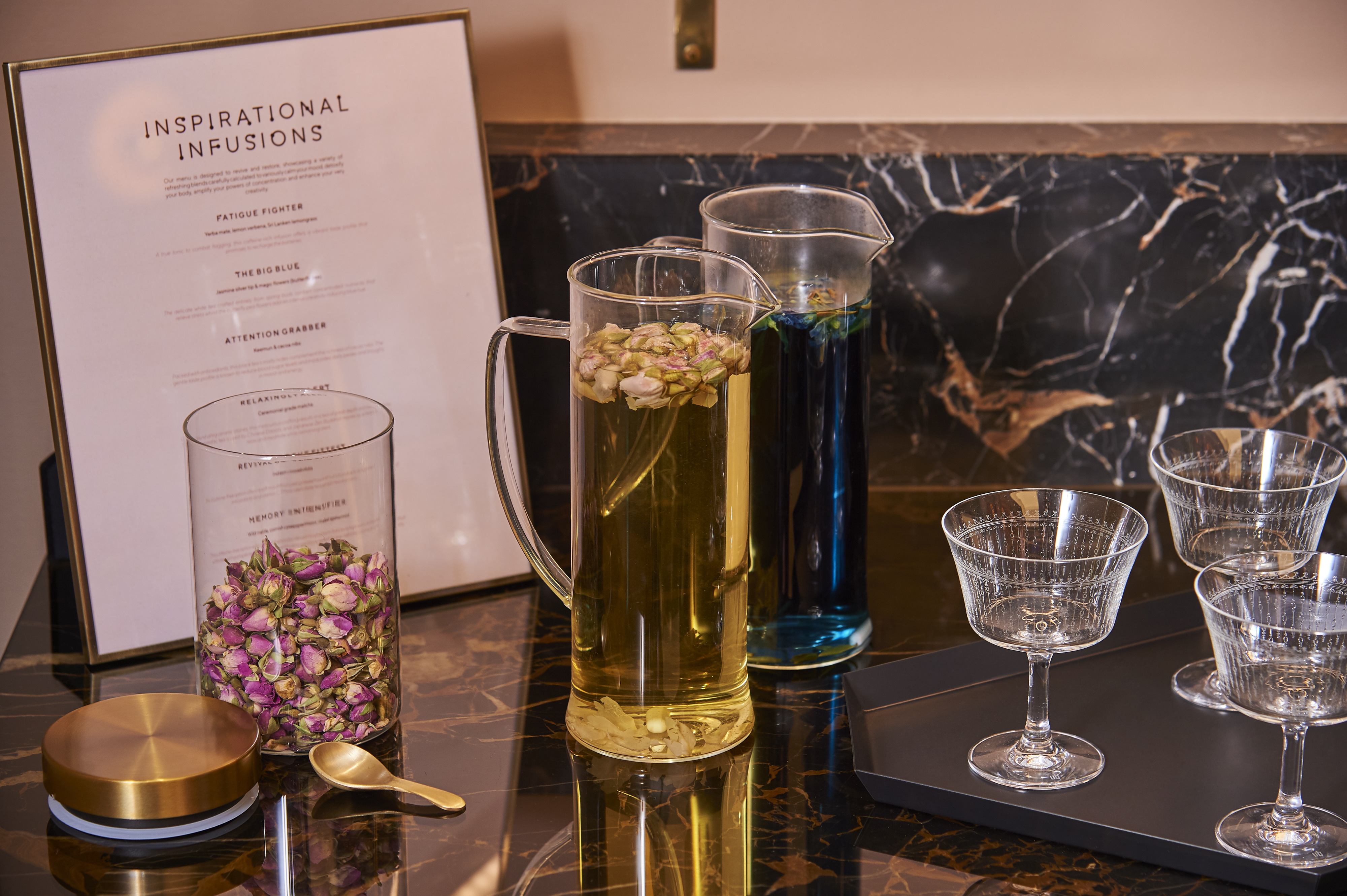 Stylish beverage station with infused drinks at AGORA, Hilton London Bankside for upscale events.