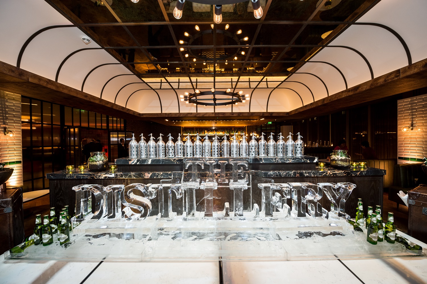 Distillery Bar event space with ice sculpture, ideal for upscale gatherings and corporate events.