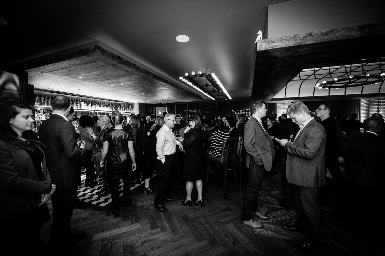 Networking event at Distillery Bar, Hilton London Bankside, featuring modern decor and lively ambiance.