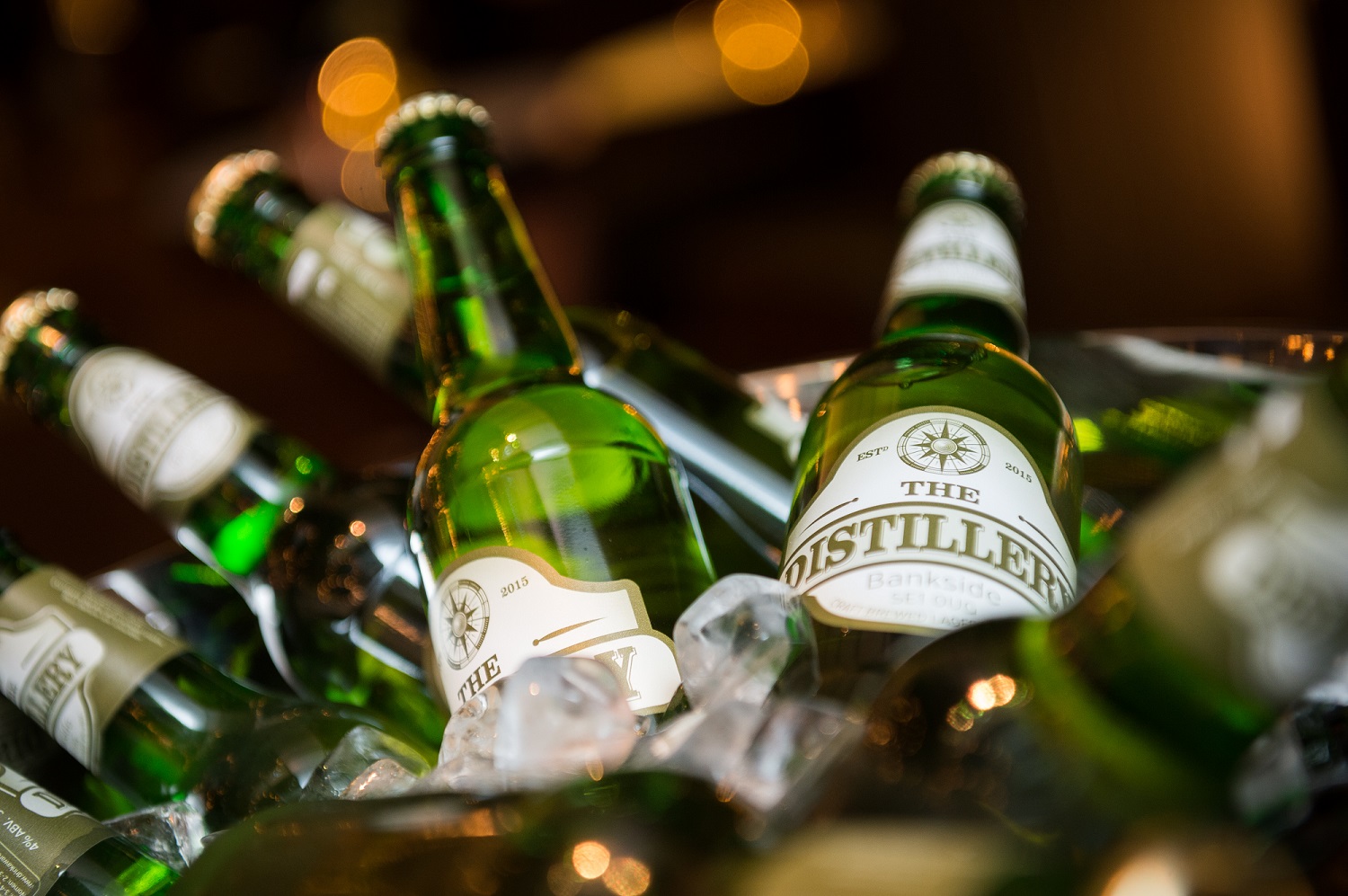 Chilled green bottles in ice at Distillery Bar, Hilton London Bankside for events.