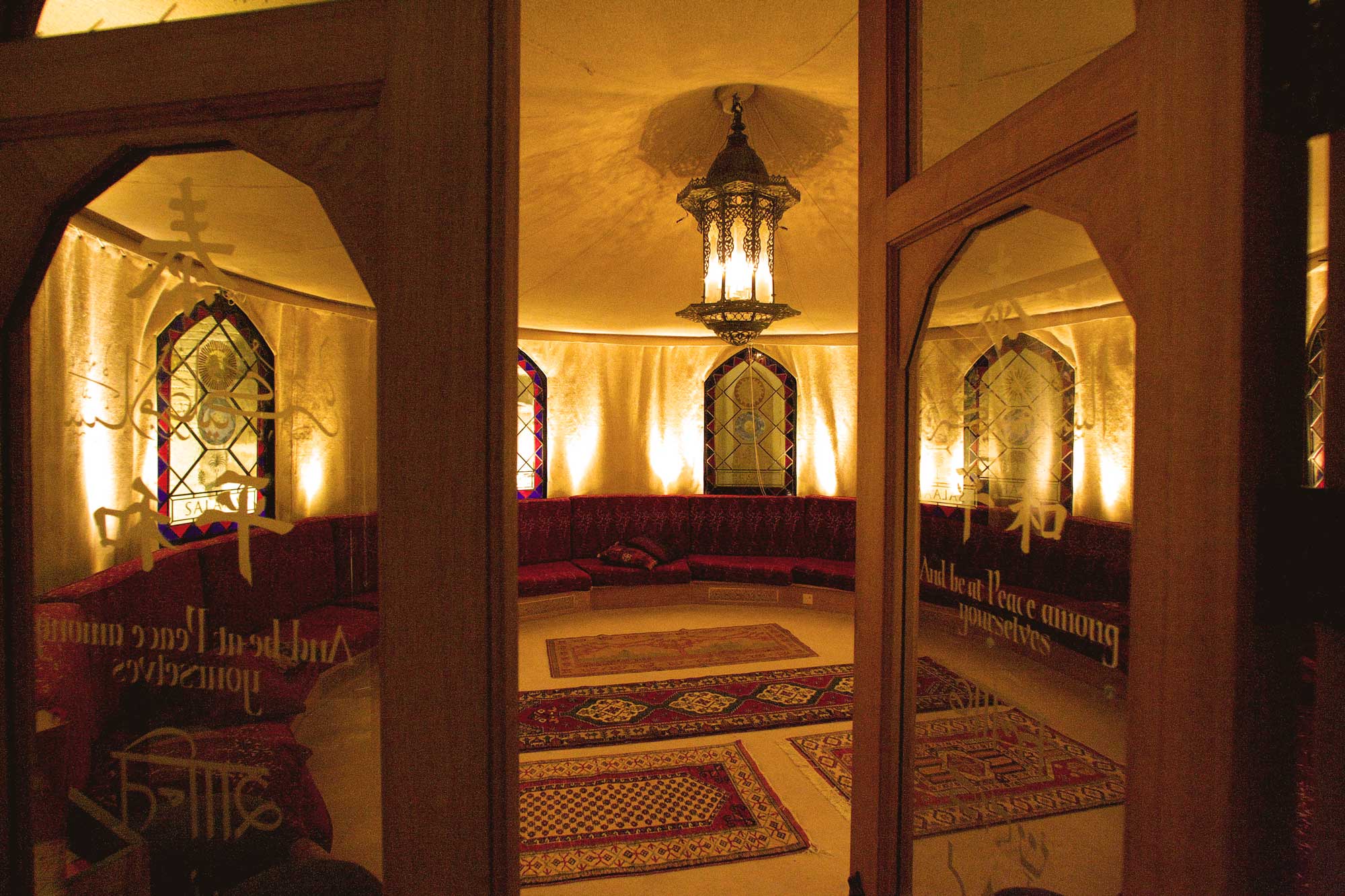 Elegant event space at The Tent, featuring arched doorways and cozy atmosphere for gatherings.