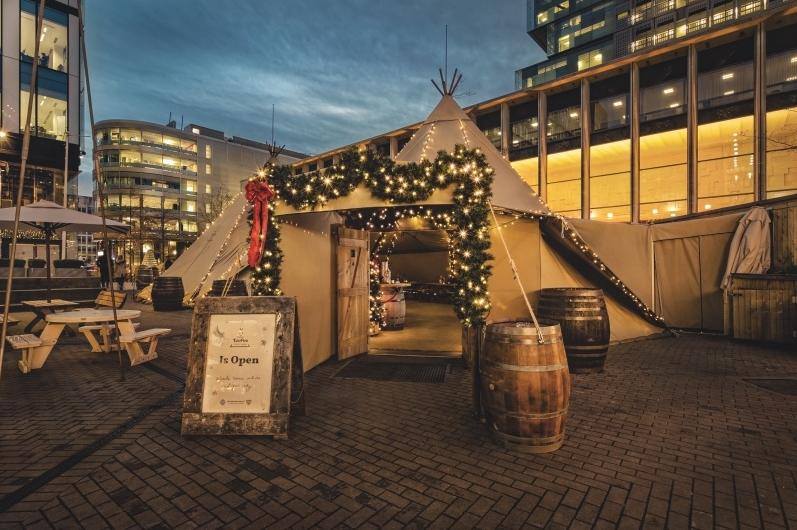Curious TeePee event tent with warm lighting for winter holiday parties and corporate events.