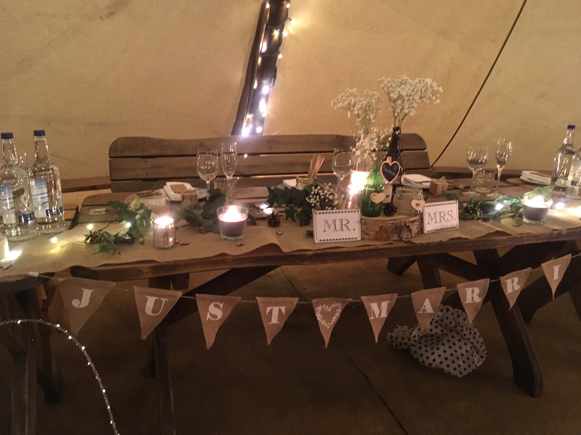 Intimate wedding reception at The Curious TeePee with rustic decor and floral accents.