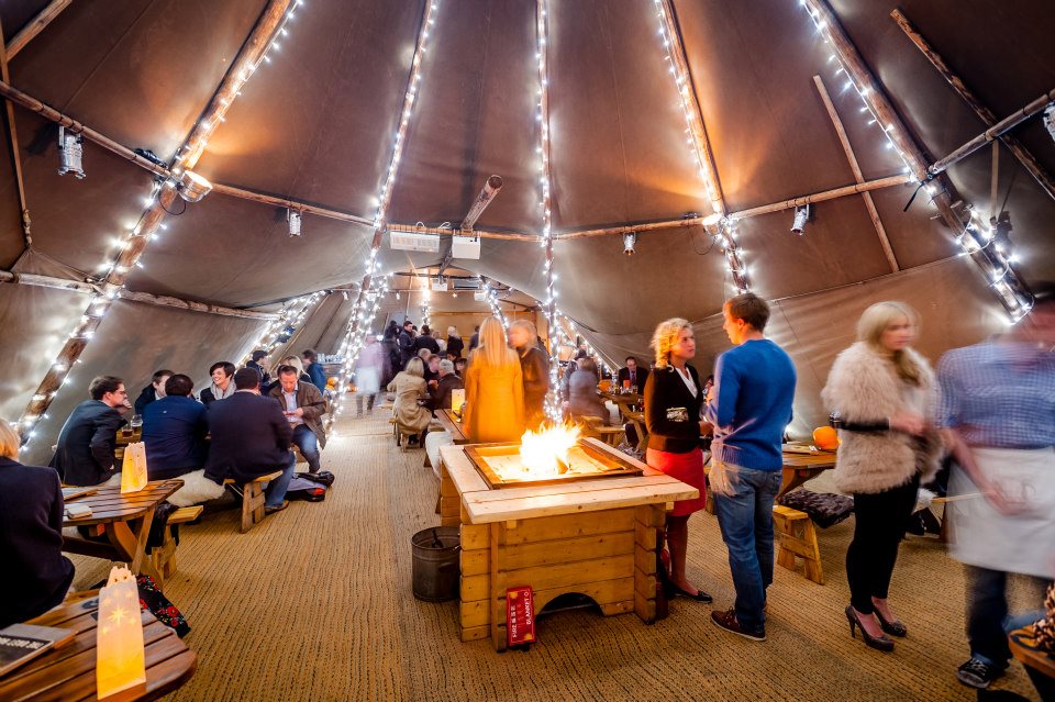 Cozy event space with warm lighting in The Curious TeePee, ideal for gatherings.