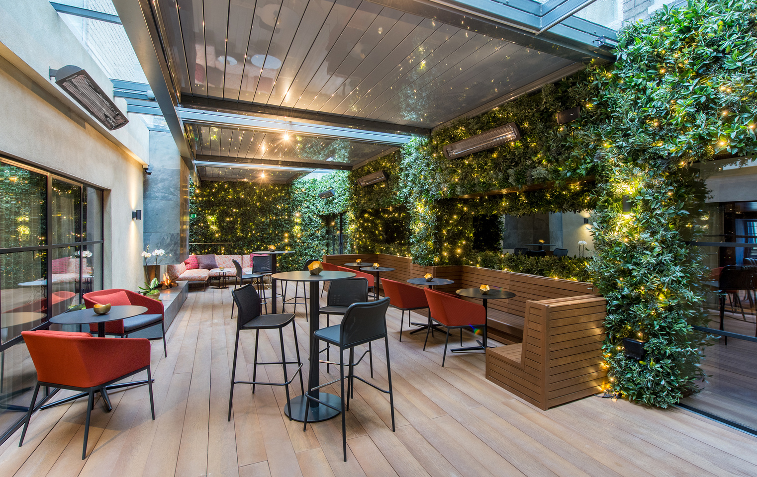 Stylish event space at The Courtyard, featuring greenery and twinkling lights for gatherings.