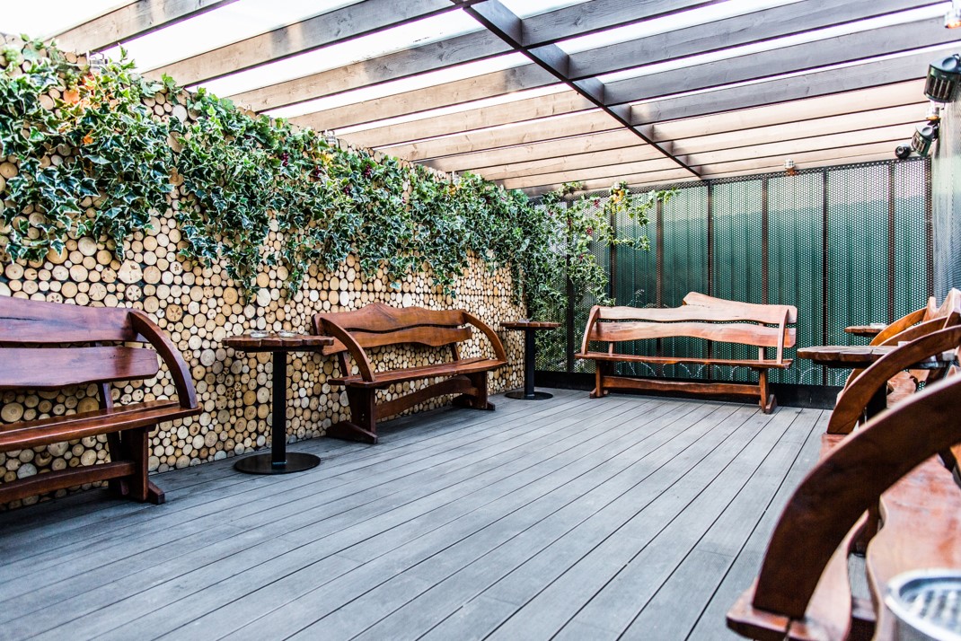 Stylish outdoor event space with wooden benches, ideal for casual gatherings in London.