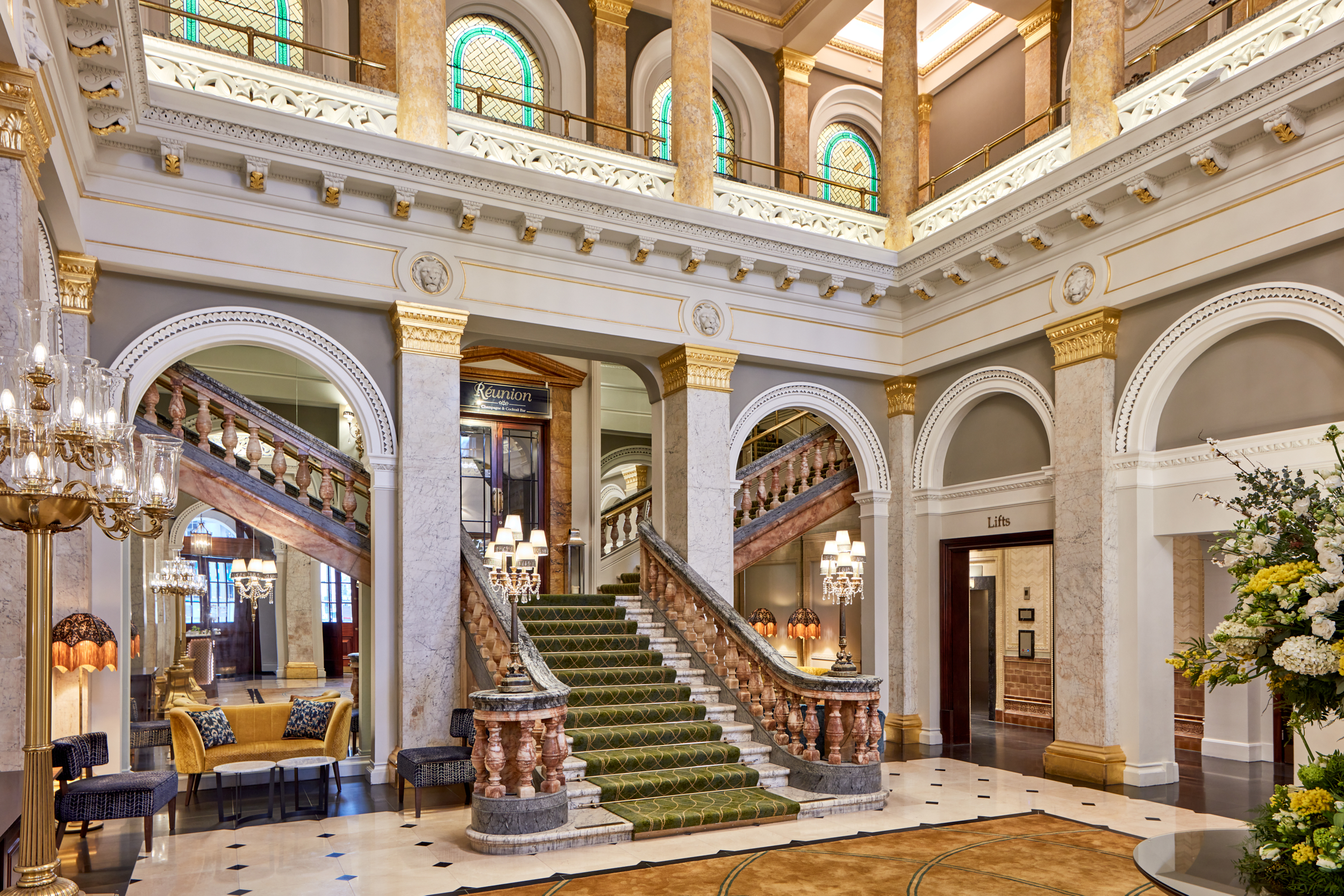 Elegant Belle Room lobby with sweeping staircase, ideal for events and gatherings.