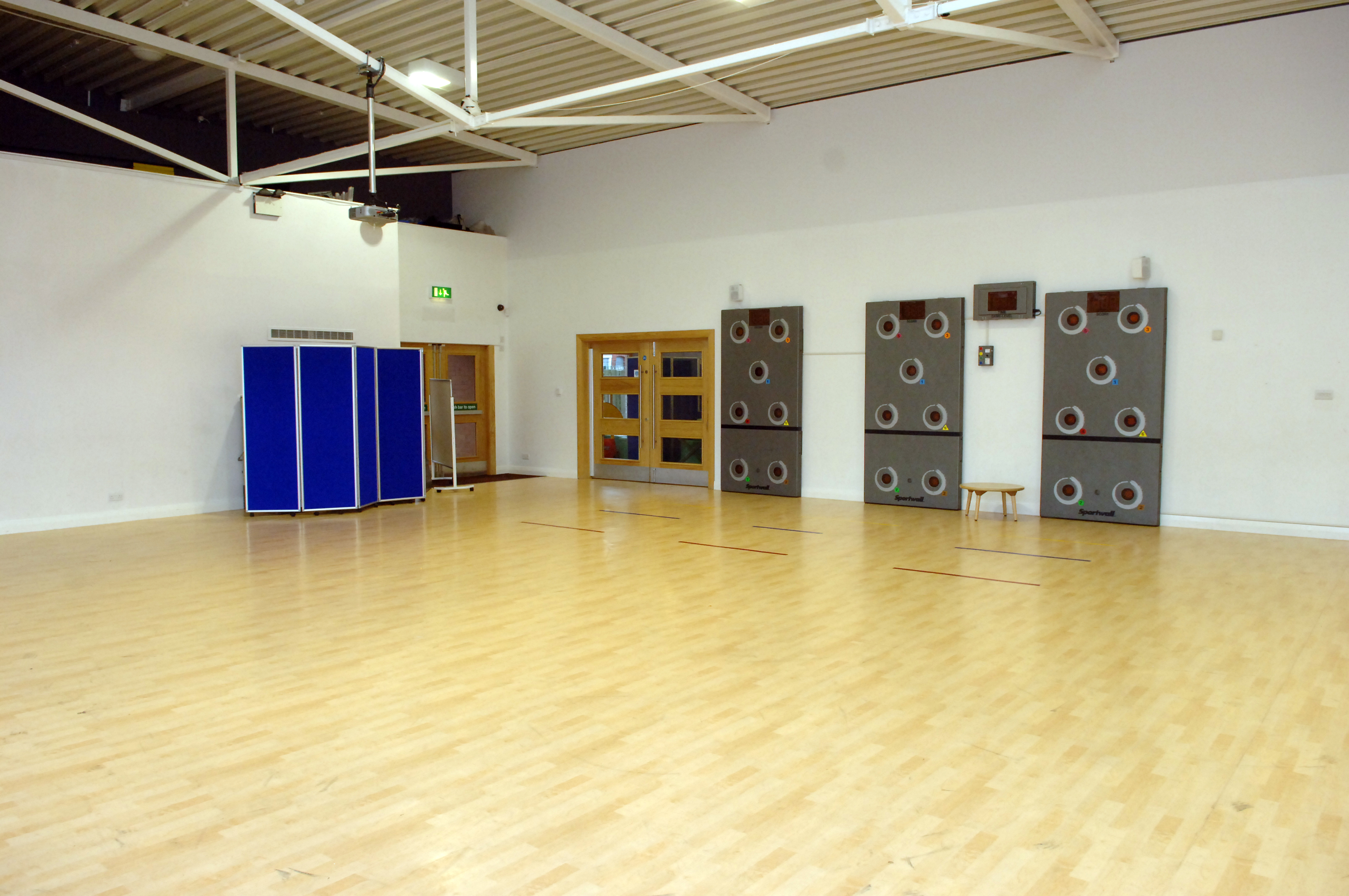 Spacious event space with polished wooden floor for workshops and gatherings in Life Bank.