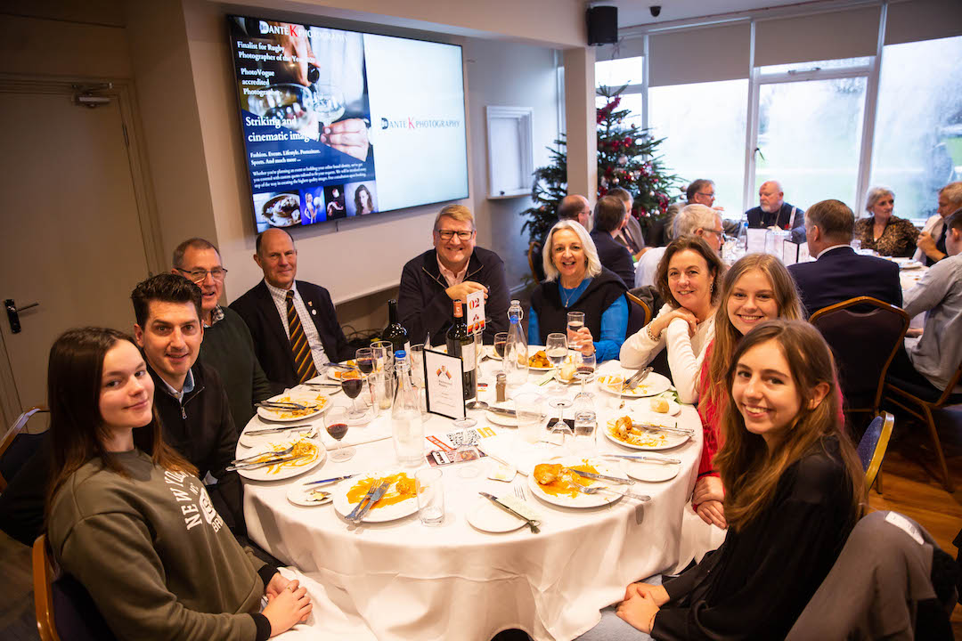 Elegant Club Room event at Richmond Athletic Ground with festive decor and multimedia setup.